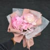 Pink peony bouquet wrapped in blush paper and white mesh