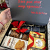 Gift box with wine, chocolates, cookies, and a small plush bear