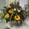 Mixed yellow and white flowers arranged in a metal basket