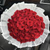 Bouquet of red roses wrapped in white paper