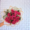 Handheld bouquet of hot pink roses with white baby's breath