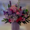 Pink and purple mixed bouquet in a lavender vase