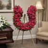 A vivid U-shaped standing tribute, this flower arrangement is a red horseshoe