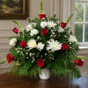 Vivid red roses set against pure white spider mums and white carnations