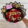 Bouquet of red and gold roses with butterfly decorations and a birthday sign