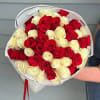 Bouquet of red and white roses wrapped in white paper