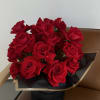 Bouquet of red roses wrapped in black paper