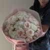 Large bouquet of pale pink roses and white hydrangeas wrapped in pink paper