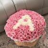Round basket arrangement of pink and white roses