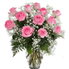 Pink roses arranged in a clear glass vase with baby's breath