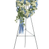Heart-shaped floral wreath on an easel with blue and white flowers