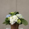 Hydrangea arrangement in a wooden basket