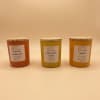 Three scented candles in glass jars with wooden lids