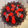 Round bouquet of red and black roses with horror-themed toppers