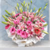 Pink lilies and gerbera daisies in a white wrapped bouquet