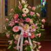 Large pink floral standing spray with lilies, roses, and gerbera daisies