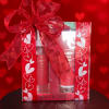 Gift box with red heart ribbon and two pink cosmetic tubes