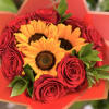 Bouquet of red roses and yellow sunflowers wrapped in orange paper