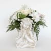 White floral arrangement in a decorative angel planter