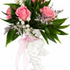 Pink roses and white filler flowers in a white cherub vase with a pink ribbon