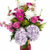Pink and white mixed bouquet in a magenta glass vase