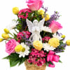 Basket arrangement of pink and yellow roses with daisies and an angel figurine