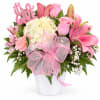 Pink and white mixed flower arrangement in a white vase with a "It's a Girl" sign