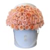 Peach and blush roses arranged in a light blue hatbox