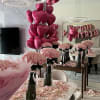 Pink rose bouquets with heart balloons in a decorated room