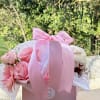 Pink rose bouquet in a gift box with a ribbon and a drink cup