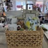 Gift basket with a mug, tea, candle, and decorative items