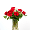 Red roses arranged in a clear glass vase with baby's breath