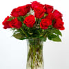 Red roses arranged in a clear glass vase