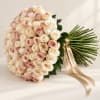 Large bouquet of blush and ivory roses tied with satin ribbons