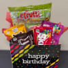 Birthday gift bag filled with assorted candy packages