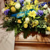Yellow and white floral spray with a blue "Father" ribbon