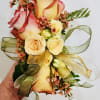 A compact, wrist corsage that reads like a miniature enchanted garden-perfect as