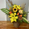 Yellow lilies and orange roses in a wicker basket