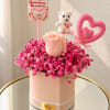 Pink rose arrangement in a round box with a teddy bear and heart toppers