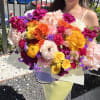 Large mixed bouquet of bright pink, yellow, orange, white, and purple flowers