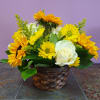 Yellow flowers and a white rose in a woven basket