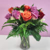 Bouquet of multicolored roses in a clear glass vase
