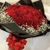 Bouquet of red roses with white baby's breath and a red ribbon