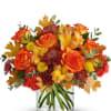 Orange and red bouquet in a clear glass vase