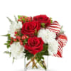 Red roses and white carnations in a clear square vase with striped ribbon accents