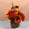 Autumn bouquet of red and yellow flowers in a turkey-shaped vase