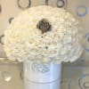 White rose bouquet in a white hatbox with a dark center rose