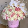 Pink and white roses with white orchids in a pink hat box