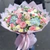 Dreamy mix of roses and hydrangeas hand tied in our Signature wrap.