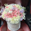 Elegant mix of roses, hydrangeas and seasonal flowers in our signature box